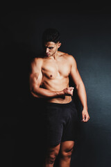 Fototapeta na wymiar shirtless muscular man on a black background