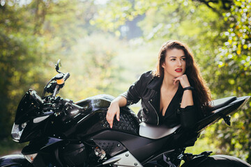 Fototapeta na wymiar Biker sexy woman sitting on motorcycle. Outdoor lifestyle portrait
