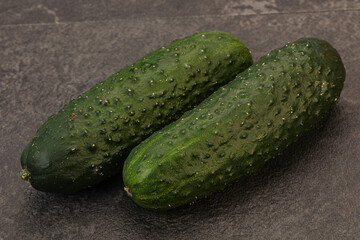 Green fresh cucumbers over background