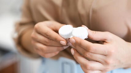 Unrecognizable woman holding contact eye lenses container