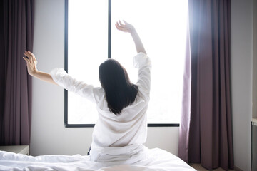 Back View of  Asian Woman Raise Her Hand Stretching in the Morning