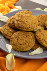oat biscuits on a plate with rose petals