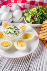 boiled chicken eggs on a white wooden rustic background