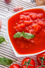 juicy canned tomatoes on wooden rustic background
