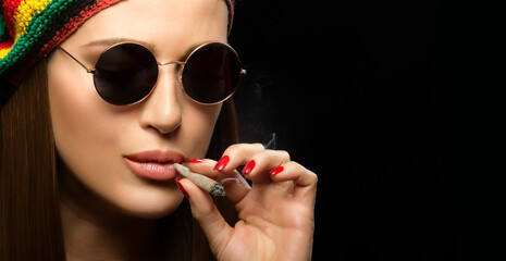Attractive hippie young woman smoking marijuana