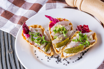 delicious snack tartlets on rustic wooden background