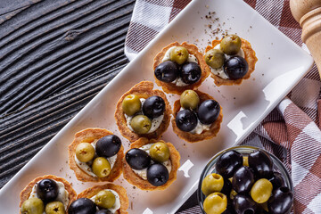 delicious snack tartlets on rustic wooden background