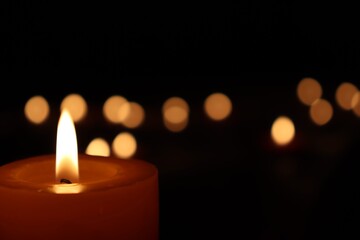 Candle black background of mourning funeral moment of silence