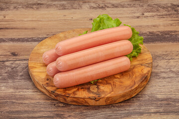 Tasty meat sausages over board