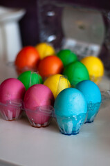 colored eggs in the egg tray