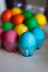 Fototapeta na wymiar colored eggs in the egg tray
