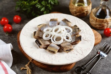 Salted herring slices with white onion rings.