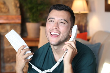 Young hispanic using retro style landline phone