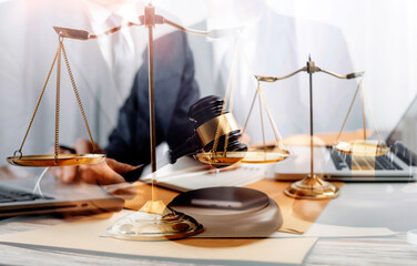 justice and law concept.Male judge in a courtroom on wooden table and Counselor or Male lawyer working in office. Legal law, advice and justice concept.