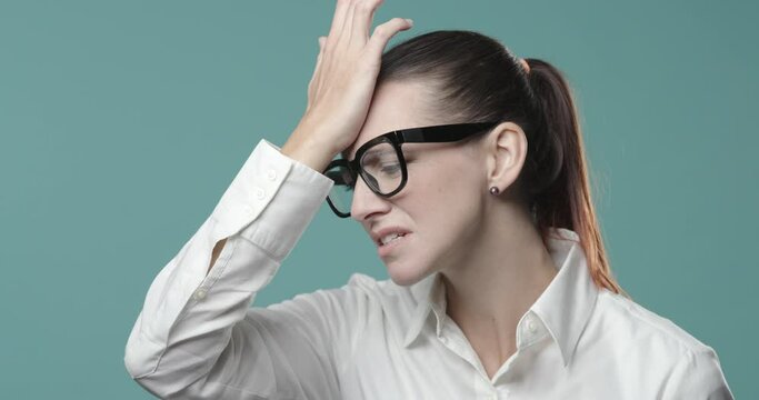 Disappointed confused woman doing a facepalm gesture