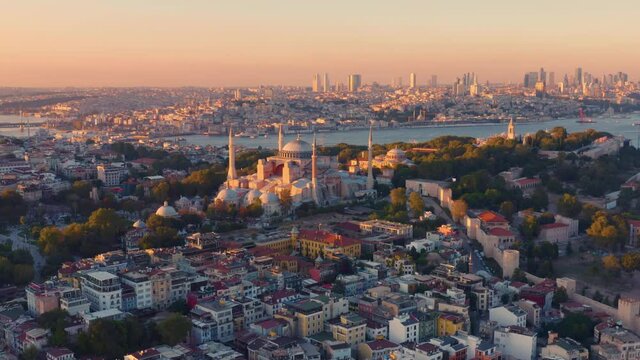 Istanbul, Hagia Sophia Grand Mosque (Ayasofya) with a Golden Horn on the background at sunset. Aerial all-round view
