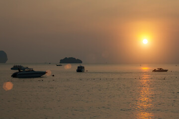 Fototapeta na wymiar Andaman Sea at sunset, boats stand at sea