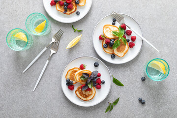 Fototapeta na wymiar Pancakes with fresh blueberry and raspberry served for healthy vegetarian breakfast