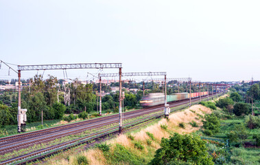 Fototapeta na wymiar Train with different freight cars that are blurred at high speed