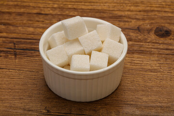 Refined white sugar cubs in the bowl