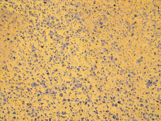 Yellow concrete texture, gravel, stones. Background, surface, wall.