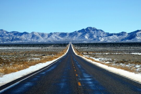 Lonely Route 93, Great Basin Highway Heading Into The Snow-capped Mountain In Lincoln County Nevada.