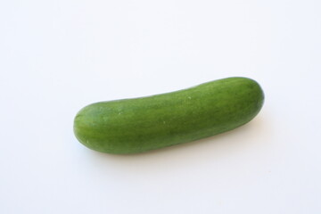 A large wide green cucumber rests on a white background