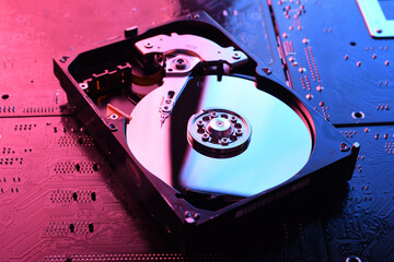 Computer Hard disk drives HDD , SSD on circuit board ,motherboard background. Close-up. With...