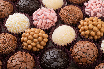 Typical brazilian brigadeiros, various flavors over wooden table