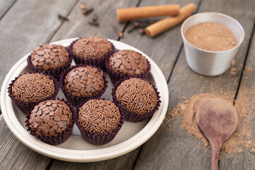 Typical brazilian brigadeiros, various flavors over wooden table