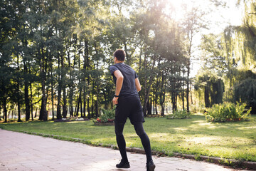 Fototapeta premium Sportsman Jog Cardio Workout. Runner Fitness Hard Training Before Running Marathon Competition. Running Man Fitness Exercising. Athlete Jogging In Park Preparing Triathlon. Sport Healthy Lifestyle