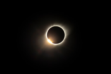 The Baily's beads effect and Diamond Ring effect during Total Solar Eclipse Chile 2019, amazing view of the Sun covered by the Moon during totality phase while the last sunbeams pass the Moon craters