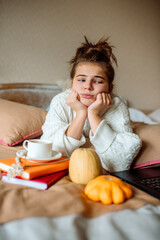 Obraz na płótnie Canvas Sad teen girl dreaming, bored, hot coffee in bed.Cozy autumn