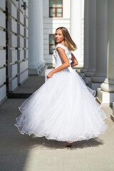 Young beautiful girl in ballroom prom dress