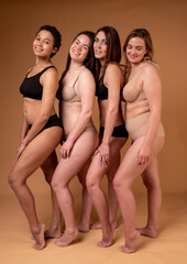 Beautiful fat girls in black lingerie on pink background. Body positive concept. Group of women with different body and ethnicity