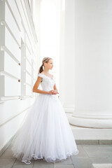 Portrait of a young woman in a white ball gown