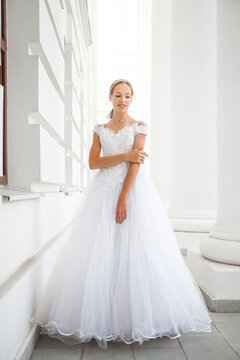 Portrait of a young woman in a white ball gown