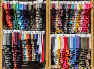 Close up view on samples of zippers in different colors found at a fabrics market.