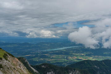 View on Drau river valley from path to Mittagskogel hill in cloudy summer day