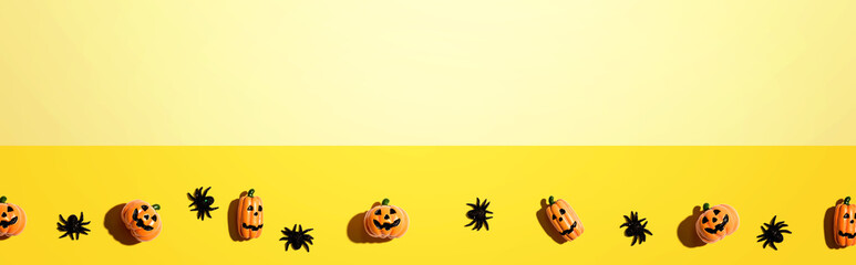 Miniature Halloween pumpkin ghosts with spiders - flat lay