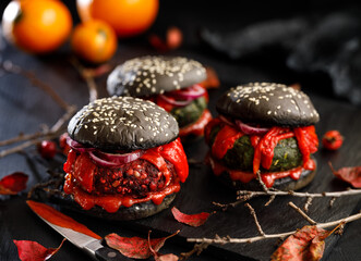 Halloween black burgers on dark background close up view. Halloween food idea for  party