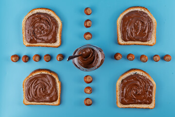 Chocolate hazelnut pasta in a jar on  a blue background