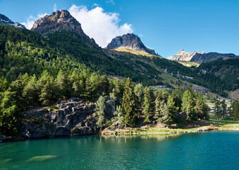 mountain lake of green color in the alps against the background of a chain of mountains