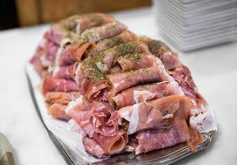 plat de morceaux de viande tranchées finement servit lors d'un événement