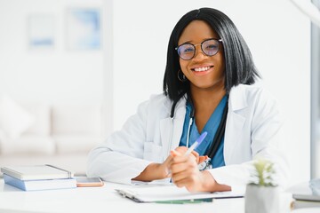 African American doctor working in her office at clinic