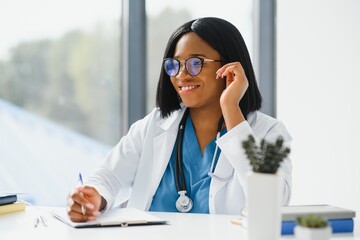 Portrait of African American woman doctor smiling in hospital