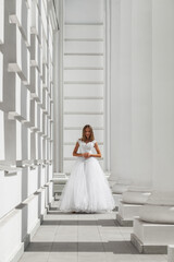 Young beautiful girl in ballroom prom dress