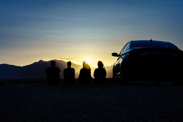  Sunset with friends in the desert. Road trip Concept