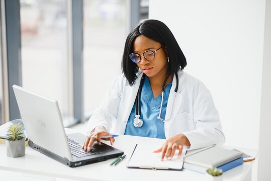 African American doctor working in her office at clinic