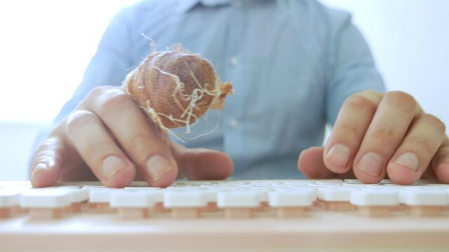 hand of a man with a bandaged finger uses a computer keyboard